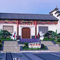 Ancient Chinese Architecture Featuring Black Tiled Roof Red Wooden Door Stone Lions And Green Plants