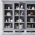 Modern White Sideboard With Glass Doors Displaying Dishes Vases And Plates