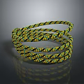 Yellow And Black Patterned Braided Rope Coiled On Reflective Surface