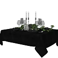 Elegant Tableware Set with Black Tablecloth Wine Glasses Candle Holders and Green Plants