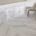 White Veined Marble Floor Tiles In Bright Room With Modern Accent Chair