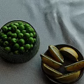 Fresh Green Peas in Glass Bowl with Lemon Slices on Wooden Plate