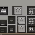 Various Black Kitchen Appliances Stacked Against Light Wall With Wooden Countertop