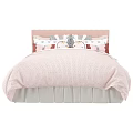 Cute Pink Children's Bed With Textured Quilt Ruffled Skirt And Patterned Pillows