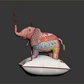 Pink Patchwork Elephant Toy Standing On White Pillow With Flower Decorations And Red Ribbons