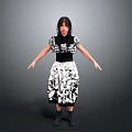 Woman In Black And White Patterned Dress Standing With Arms Outstretched Against Gray Background