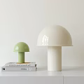 Modern Green And White Mushroom Shaped Table Lamps On Books And Table