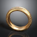 Shiny Gold Bracelet Featuring Intricate Carved Patterns And Reflective Surface