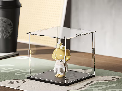 Cute Yellow Doll In Clear Transparent Display Case Placed On Table With Green Mat Background 3d model