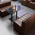 Brown Leather Two Seater Sofa With Black Glass Top Side Table And Wine Bottles Candle