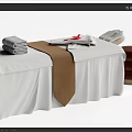 Elegant Massage Bed Setup With White Sheets Brown Towel And Stacked Towels