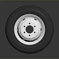 Car Tire With Silver Metal Rim And Tread Pattern On Dark Background