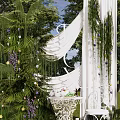 Outdoor Photo Check in Spot With White Arch Green Vines Purple Flowers And Lawn Trees