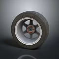 Car Tire With Alloy Wheel Rim And Red Center Cap On Gray Background