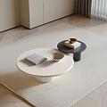 Modern White And Black Coffee Tables On Beige Rug With Book Cup Box And Bowl