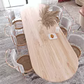 Elegant Restaurant Dining Area With Wooden Oval Table Metal Frame Woven Chairs And Vase Decor