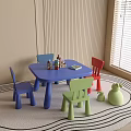 Children's Blue Table and Multi Colored Chairs Set with Toys in Kids Room