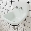 Modern Wall Mounted Washbasin On Black And White Grid Tiled Wall With Silver Drain Pipe