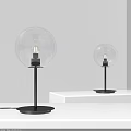 Two Modern Minimalist Table Lamps With Glass Globe Shade And Black Base On White Shelf