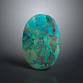 Polished Oval Turquoise Stone with Speckled Green and Brown Patterns on Dark Background
