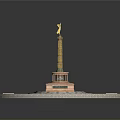 Monument Structure With Golden Statue On Circular Base And Green Lawn Cross Pathways