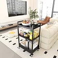 Cozy Living And Dining Room With Beige Sofa Black Shelf Fruits Snacks Books White Table