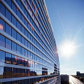 Aerial Planning of Modern Urban Buildings With Glass Curtain Walls Under Bright Sunlight