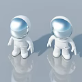 Two White Astronaut Figurines With Silver Helmets On Gray Background With Reflections 3d model