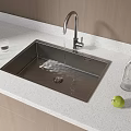 Stainless Steel Kitchen Sink With Running Water Faucet Green Apples Glass Cups On White Countertop