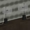 Two Modern Table Lamps With Transparent Crystal Shade And Black Base Illuminated On Table
