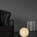 Spherical Table Lamp With Soft Glowing Light Beside Black Leather Sofa And Open Book 3d model