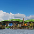 Charming Hobbit House With Green Turf Roof Round Blue Door Wooden Fence And Pumpkins