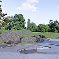 Serene Garden Landscape Design With Rock Formations Waterfall And Lush Greenery Blooming Flowers Stone Paths