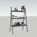 Black Ladder Shelf With Decorative Plants And Miniature Ornaments For Indoor Garden