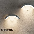 Pair of Modern Arched Wall Lamps Mounted On Gray Wall With Illuminated Design