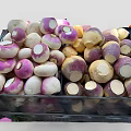 Fresh Purple and White Turnips Stacked in Black Crates at Market