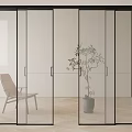 Modern Glass Sliding Doors with Black Frames in Interior Room Featuring Chair And Plant