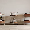 Three Rolling Side Tables With Wooden Shelves Metal Frames Fruits Wine Glasses And Books