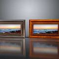 Two Photo Frames With Silver And Wooden Borders Displaying Seascape Sunset Photos On Reflective Surface