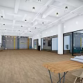 Public Office Space With Spacious Layout Wooden Flooring Ceiling Lights And Glass Partitions