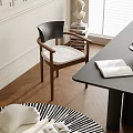 Modern Wooden Dining Chair With Black Backrest White Cushion Near Dark Table And Book On Wooden Floor