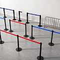 Stanchion Barriers with Blue and Red Straps Black Metal Poles Arranged on Gray Floor