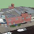 Modern Building With Solar Panels On Roof Near Water And Boats