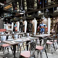 Marvel Heroes Themed Restaurant With Industrial Style Metal Tables Chairs And Hero Statues