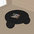 Modern Round Black Coffee Table With Ball Shaped Legs And Books On Top