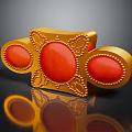 Golden Decorative Object Featuring Oval Shaped Red Gemstones and Ornate Patterns