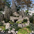 Natural Garden Ornament With Rockery Stone Arrangement Water Lilies And Lush Greenery