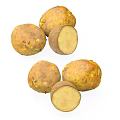 Fresh Yellow Fruit with Brown Spots Whole and Sliced on White Surface