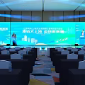 Large Conference Hall Setup With Stage Big Screen And Arranged Seats For New Journey Event