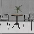 Modern Round Wooden Table With Black Metal Wire Mesh Chairs And Green Plant